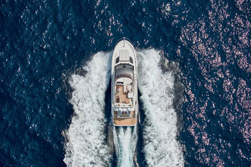  Yacht Photos Pics Aerial view of 2026 Prestige F4.9 yacht cruising through blue ocean waters.