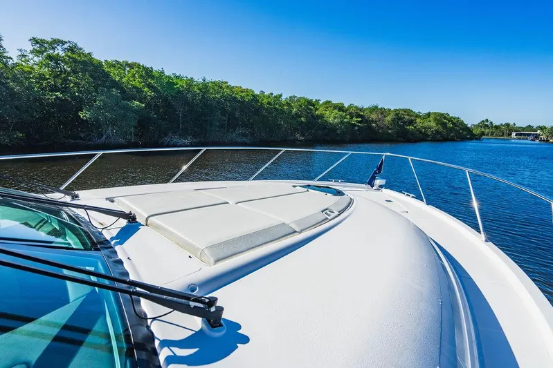 Happy Daze IV Yacht Photos Pics 2017 Tiara Yachts 53 Coupe on serene water with lush greenery.