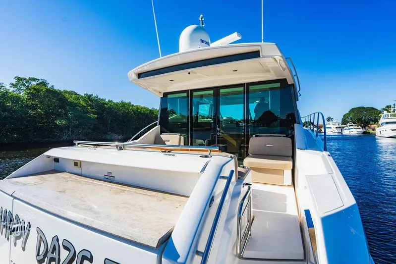 Happy Daze IV Yacht Photos Pics 2017 Tiara Yachts 53 Coupe on water, sleek design, sunny day, luxury boating experience.