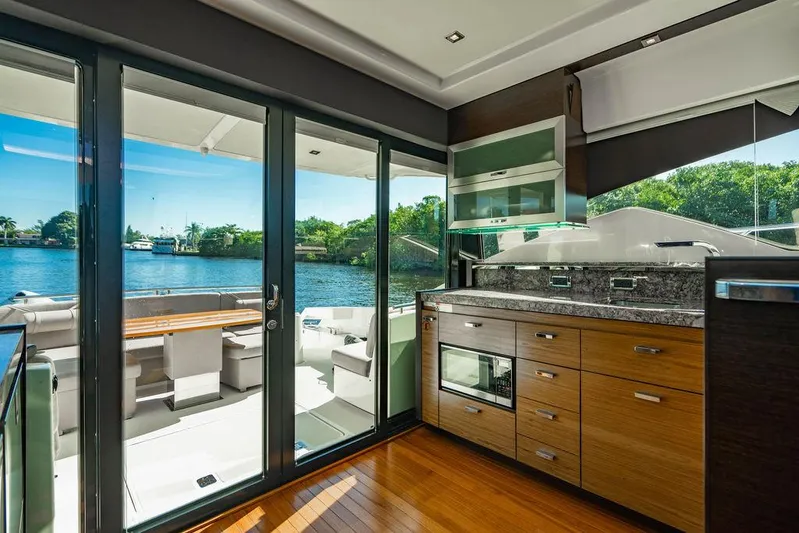 Happy Daze IV Yacht Photos Pics Interior of 2017 Tiara Yachts 53 Coupe with modern kitchen and outdoor seating area.