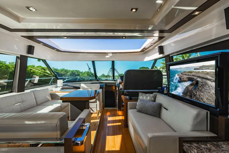 Happy Daze IV Yacht Photos Pics Luxurious interior of 2017 Tiara Yachts 53 Coupe with elegant seating and panoramic windows.