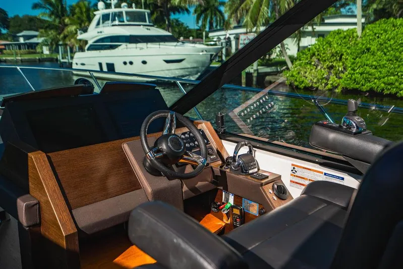 Happy Daze IV Yacht Photos Pics Helm of 2017 Tiara Yachts 53 Coupe with luxurious interior and waterfront view.