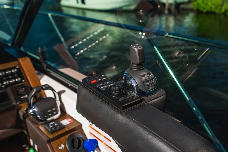 Happy Daze IV Yacht Photos Pics Control panel of a 2017 Tiara Yachts 53 Coupe, featuring joystick and navigation controls.