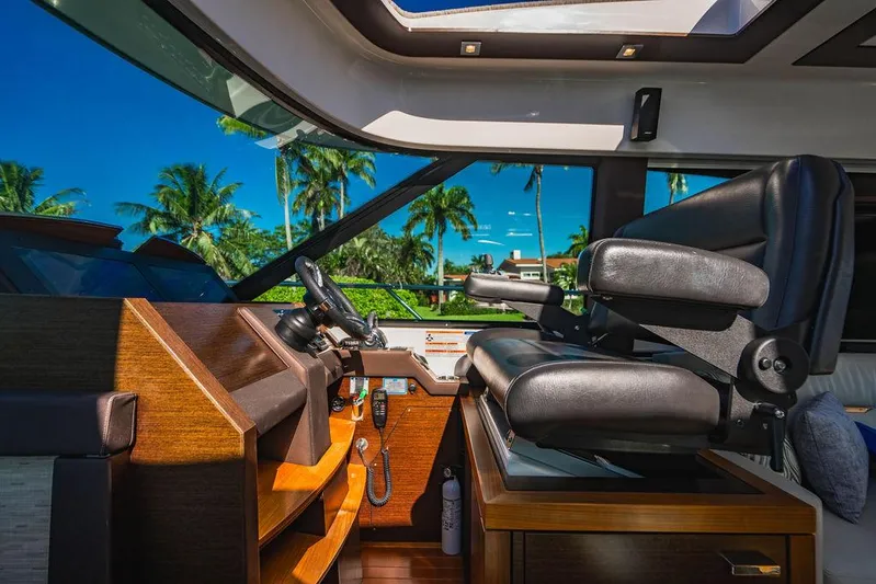 Happy Daze IV Yacht Photos Pics Interior of 2017 Tiara Yachts 53 Coupe with luxurious helm and tropical view.