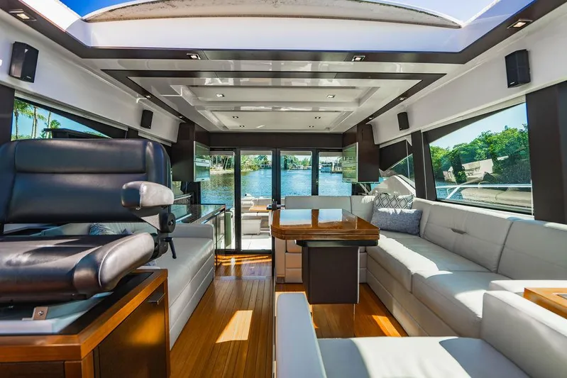 Happy Daze IV Yacht Photos Pics Luxurious interior of 2017 Tiara Yachts 53 Coupe with modern seating and panoramic windows.