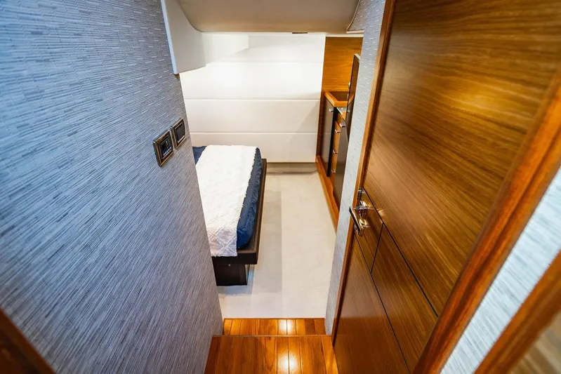 Happy Daze IV Yacht Photos Pics Luxurious interior of 2017 Tiara Yachts 53 Coupe, featuring a cozy bedroom.