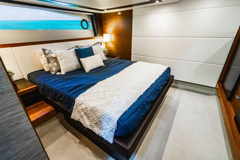 Happy Daze IV Yacht Photos Pics Luxurious bedroom interior of 2017 Tiara Yachts 53 Coupe with elegant bedding and modern design.