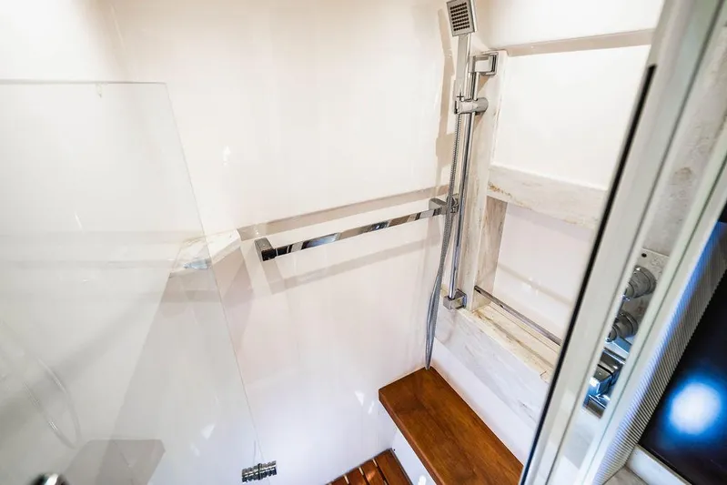 Happy Daze IV Yacht Photos Pics Shower area in 2017 Tiara Yachts 53 Coupe, featuring modern fixtures and wooden accents.