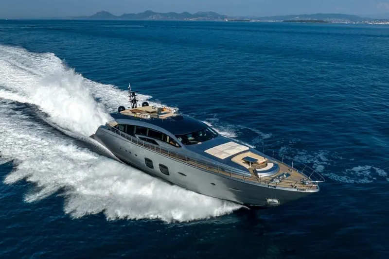  Yacht Photos Pics Luxurious 2013 Pershing 108 yacht cruising on open sea with scenic coastline.