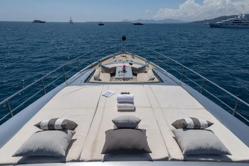 Yacht Photos Pics Luxurious 2013 Pershing 108 yacht deck with cushions, ocean view, and distant yachts.