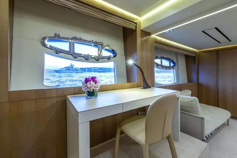  Yacht Photos Pics Luxurious interior of 2013 Pershing 108 yacht with desk, chair, and ocean view.