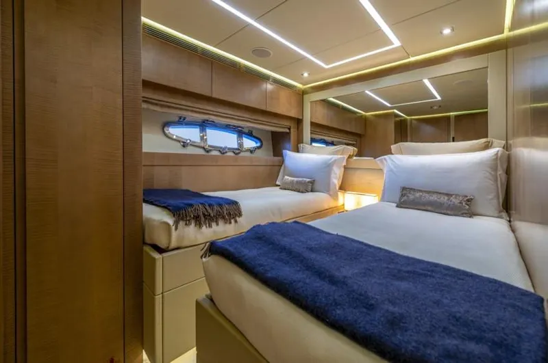  Yacht Photos Pics Luxurious twin cabin interior on 2013 Pershing 108 yacht, featuring elegant bedding and ambient lighting.