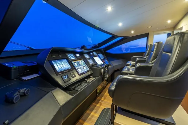  Yacht Photos Pics Cockpit of 2013 Pershing 108 yacht with modern navigation equipment and leather seating.