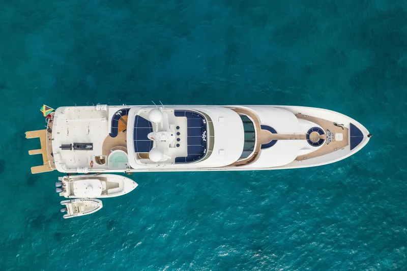 Avalina Yacht Photos Pics Aerial view of 2003 Westport yacht on clear blue water, with two smaller boats docked.