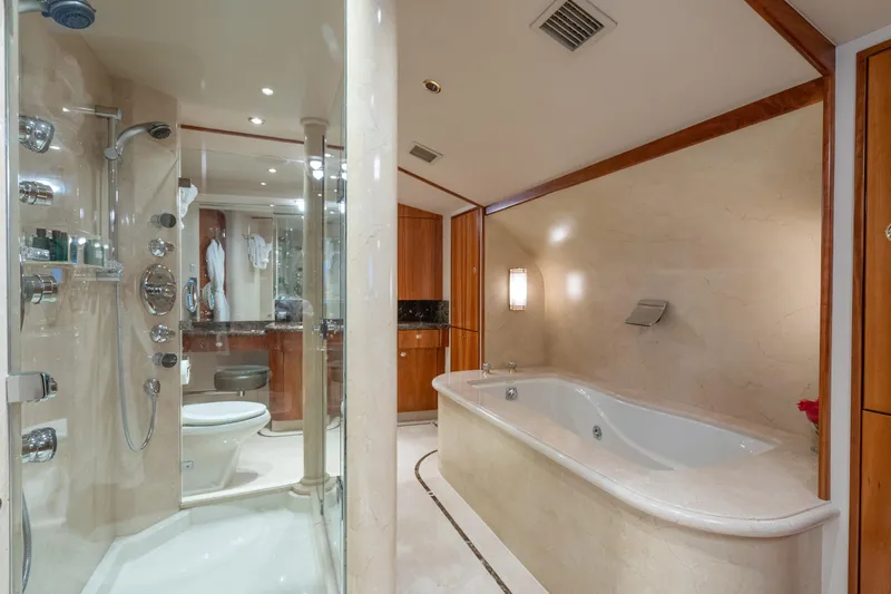 Avalina Yacht Photos Pics Luxurious yacht bathroom with marble finishes, glass shower, and elegant bathtub, Westport 2003 model.