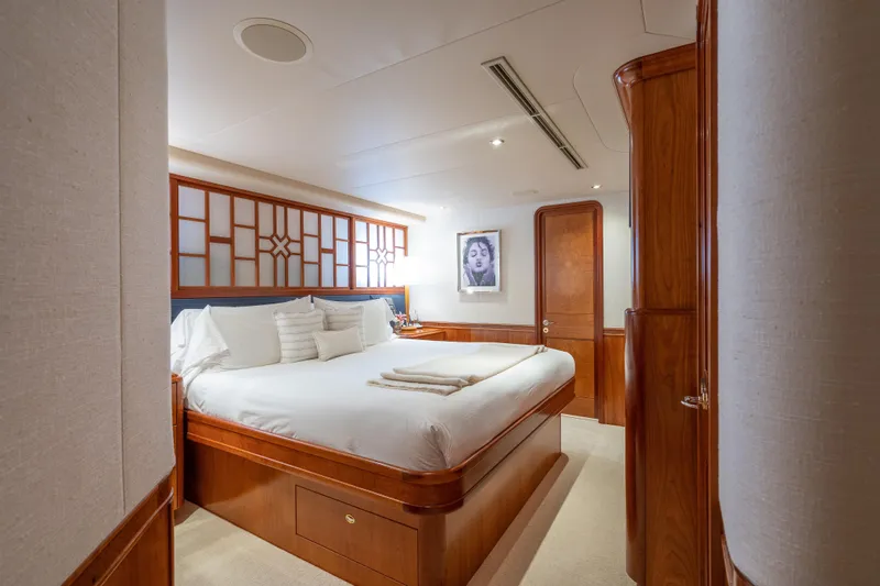 Avalina Yacht Photos Pics Luxurious bedroom interior on a 2003 Westport yacht, featuring elegant wood finishes and modern decor.