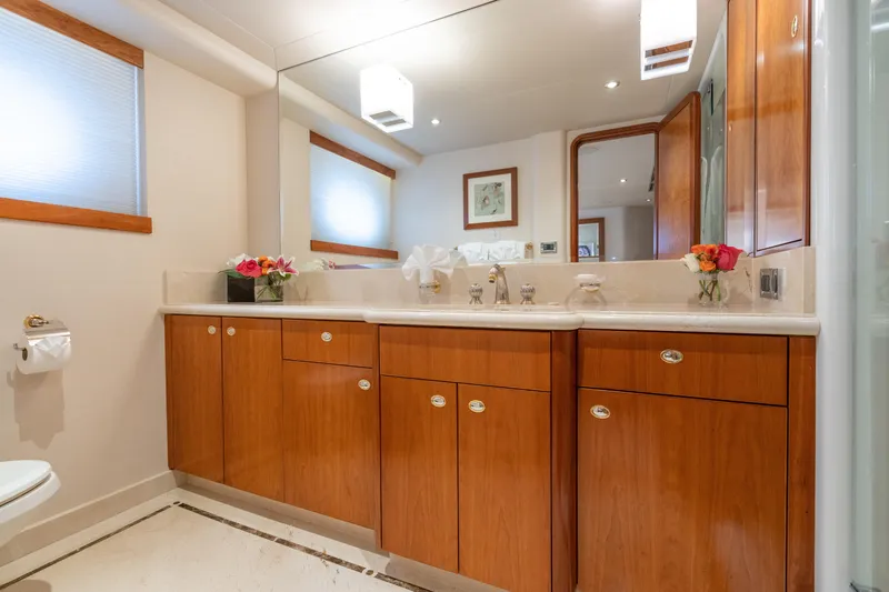 Avalina Yacht Photos Pics Luxurious bathroom with wooden cabinetry, large mirror, and elegant decor on a 2003 Westport model.