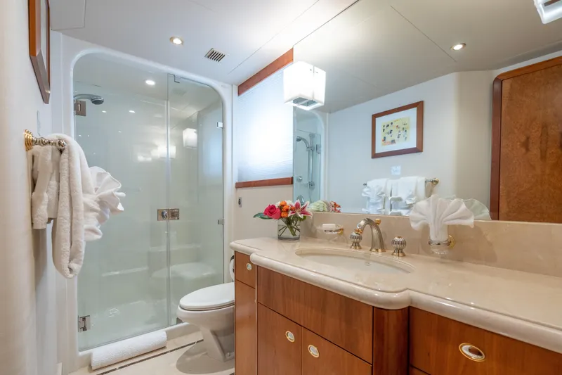 Avalina Yacht Photos Pics Luxurious yacht bathroom with glass shower, elegant vanity, and floral decor, Westport 2003 model.