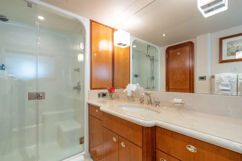 Avalina Yacht Photos Pics Luxurious bathroom in 2003 Westport yacht with glass shower and elegant wood cabinetry.