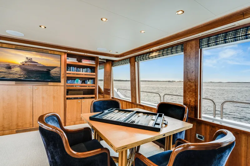 Avalina Yacht Photos Pics Luxurious 2003 Westport yacht interior with ocean view, featuring a game table and TV.