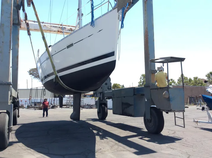 Annarosa Yacht Photos Pics 2005 Beneteau 373 sailboat being lifted by a boat hoist in a marina.