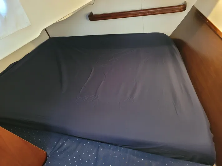 Annarosa Yacht Photos Pics Interior cabin bed of 2005 Beneteau 373 sailboat with dark bedding.