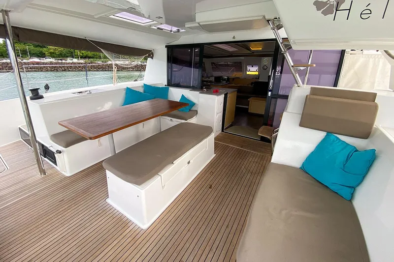  Yacht Photos Pics 2014 Fountaine Pajot Helia 44 catamaran interior with seating, table, and cushions.