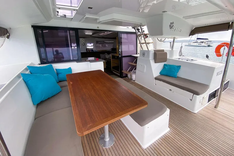  Yacht Photos Pics Luxurious 2014 Fountaine Pajot Helia 44 catamaran interior with seating and wooden table.