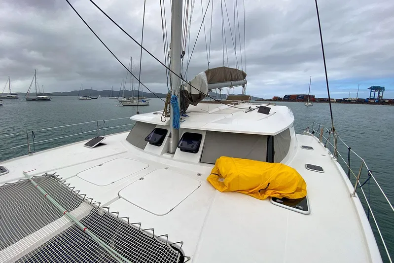  Yacht Photos Pics 2014 Fountaine Pajot Helia 44 catamaran on water, cloudy sky, yellow cover on deck.