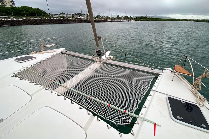  Yacht Photos Pics 2014 Fountaine Pajot Helia 44 catamaran with netting on deck, docked in a marina.