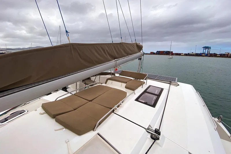  Yacht Photos Pics 2014 Fountaine Pajot Helia 44 catamaran with cushioned deck, moored in a harbor.