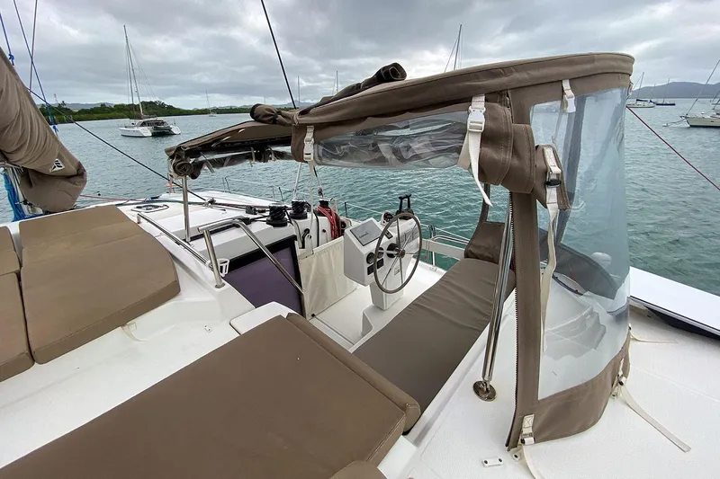  Yacht Photos Pics 2014 Fountaine Pajot Helia 44 catamaran helm station with brown seating and clear canopy.