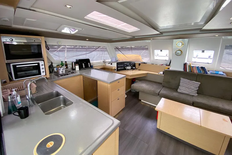  Yacht Photos Pics Interior of 2014 Fountaine Pajot Helia 44 catamaran with modern kitchen and cozy seating area.
