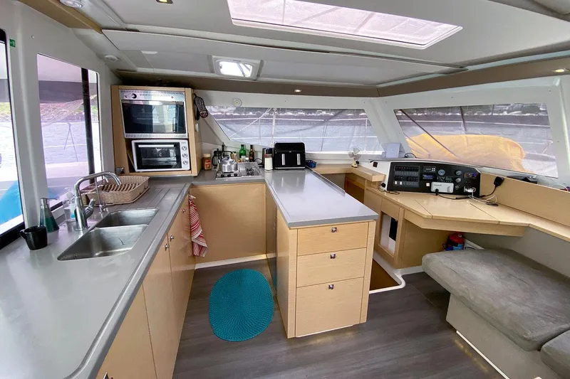  Yacht Photos Pics Interior of 2014 Fountaine Pajot Helia 44 catamaran, featuring modern kitchen and navigation area.