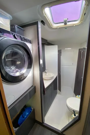  Yacht Photos Pics Bathroom with washer in 2014 Fountaine Pajot Helia 44 catamaran, featuring modern fixtures and skylight.