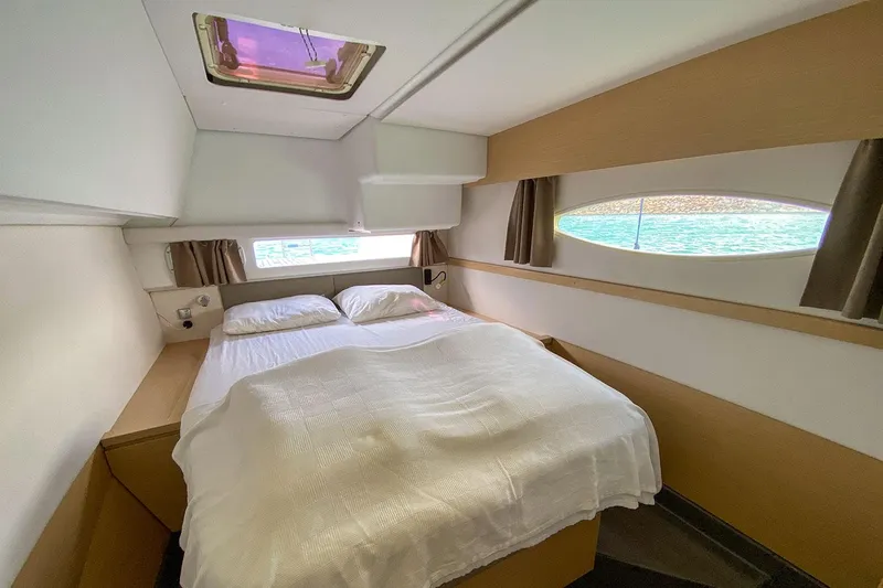  Yacht Photos Pics Luxurious cabin interior of 2014 Fountaine Pajot Helia 44 catamaran with double bed.