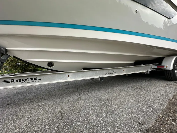  Yacht Photos Pics 2019 Regal 33 SAV boat on AmeraTrail trailer, parked on asphalt.