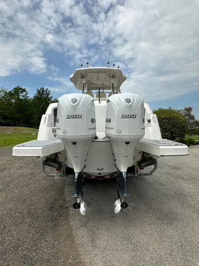  Yacht Photos Pics 2019 Regal 33 SAV boat with twin Yamaha 300 engines, parked outdoors.