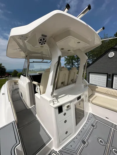  Yacht Photos Pics 2019 Regal 33 SAV boat interior with seating and storage, under a clear blue sky.