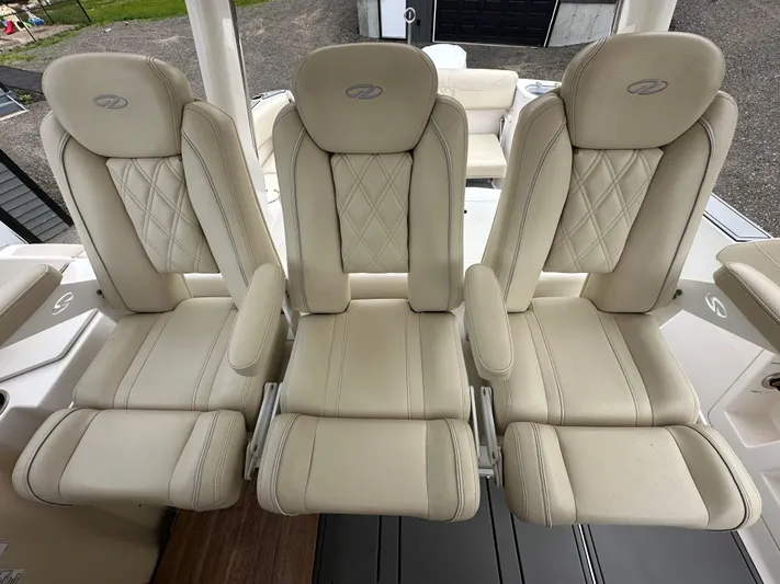 Yacht Photos Pics Three luxurious beige seats on a 2019 Regal 33 SAV boat.