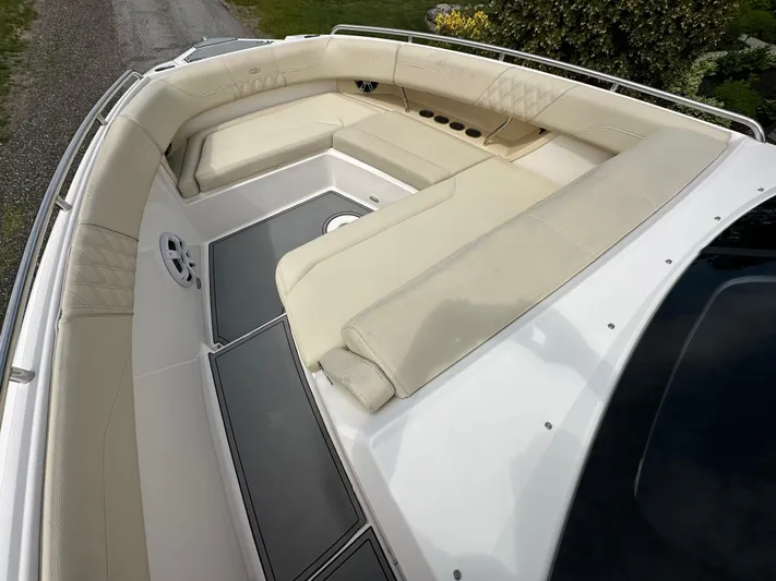  Yacht Photos Pics 2019 Regal 33 SAV boat with spacious beige seating area and sleek design.
