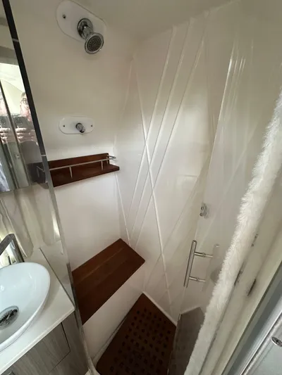  Yacht Photos Pics Compact shower in 2019 Regal 33 SAV boat with wooden accents and modern fixtures.
