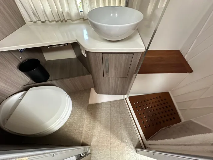  Yacht Photos Pics 2019 Regal 33 SAV bathroom with modern sink, toilet, and wooden accents.