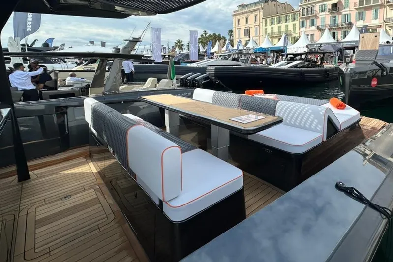 Chou Chou Yacht Photos Pics Luxurious 2023 Maori M 46 yacht with elegant seating at a marina event.