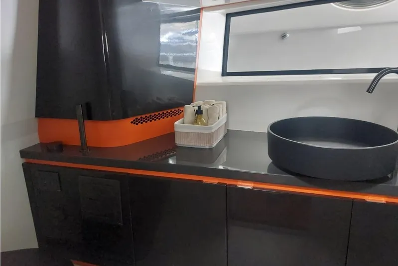 Chou Chou Yacht Photos Pics Modern bathroom interior of 2023 Maori M 46 yacht with sleek black and orange design.