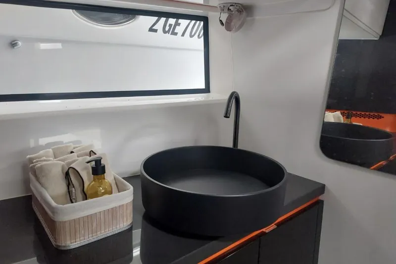 Chou Chou Yacht Photos Pics Modern bathroom sink in 2023 Maori M 46 yacht, featuring sleek black basin and minimalist design.