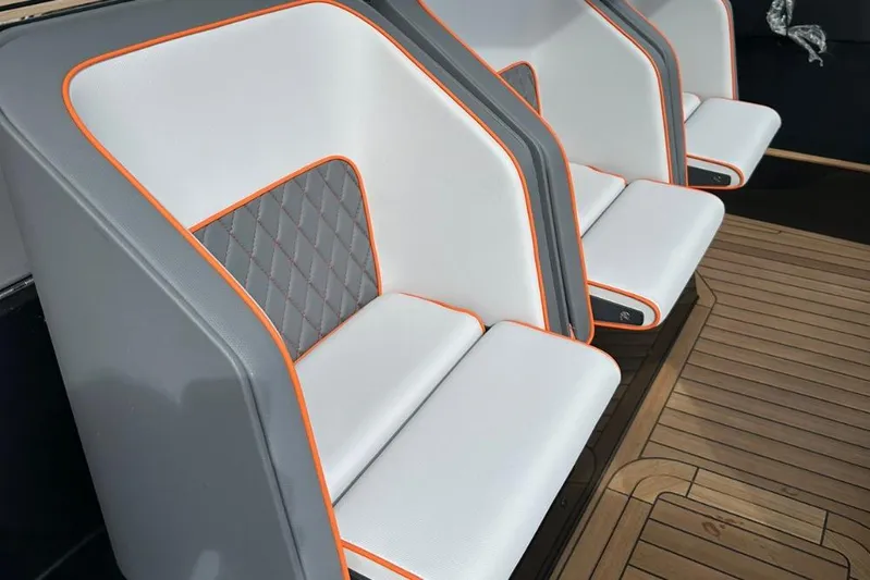 Chou Chou Yacht Photos Pics Luxury seating on 2023 Maori M 46 yacht with orange accents and quilted design.