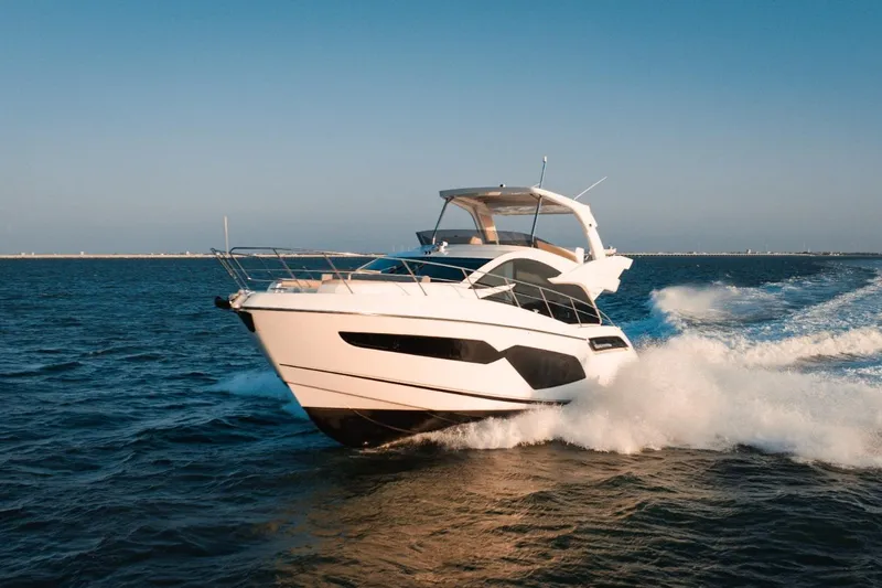  Yacht Photos Pics 2024 Sunseeker Manhattan 55 yacht cruising on open water, showcasing sleek design and luxury.