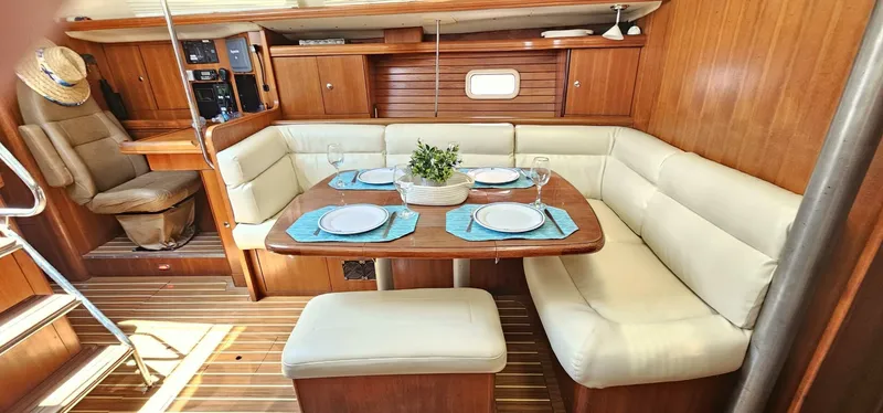 Momentum Yacht Photos Pics Luxurious 2007 Hunter 45 Center Cockpit interior with elegant dining area and plush seating.