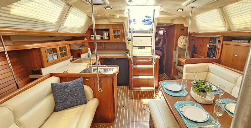 Momentum Yacht Photos Pics Luxurious 2007 Hunter 45 Center Cockpit interior with elegant dining area and modern kitchen.
